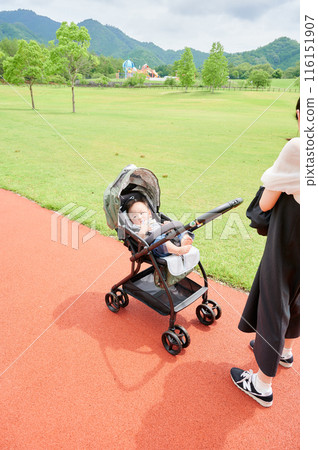 Baby in a stroller and mother childcare Baby in a stroller and mother childcare 116151907