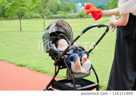 Baby in a stroller and mother childcare 116151909