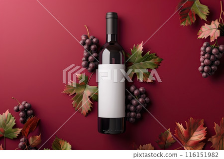 Expensive red wine in bottle with fresh grape bunches on dark red background, top view. Space for text. Overhead view. Wine bottle lying down on magenta surface. Gastronomic product still life. Banner 116151982