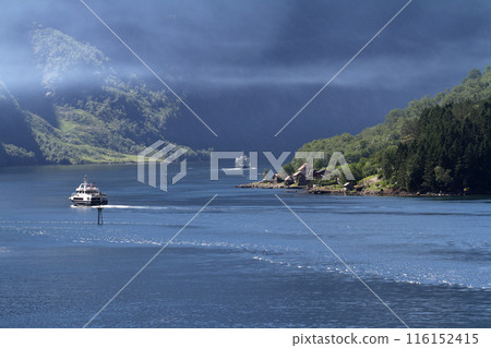A sightseeing boat ride through the canyons of a Norwegian fjord 116152415