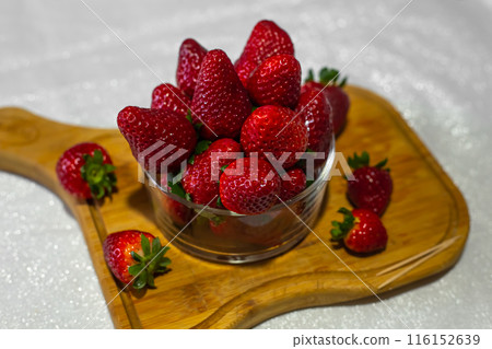 Fresh strawberries in a bowl on the table 116152639