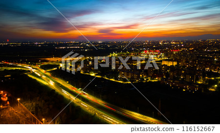 Drone photo huge multi-lane circle roundabout intersection in city traffic highway night city. Public transport commuter pollution business concept. Milan, Italy. Drone photo huge multi-lane circle roundabout intersection in city traffic highway night city. Public transport commuter pollution business concept. Milan, Italy. 116152667