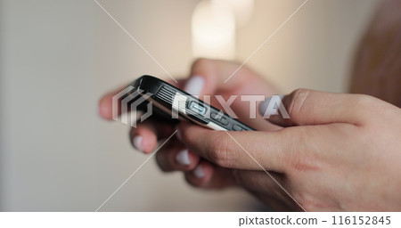 Hand of woman using texting mobile phone or chat. Close up of woman hand. Concept of surfing internet using mobile device. 116152845