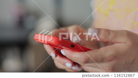 Hand of woman using texting mobile phone or chat. Close up of woman hand. Technology, communication concept. 116152867