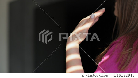 Close up young woman waving her hands because of the heat and turned on the air conditioning. Modern technologies. Close up young woman waving her hands because of the heat and turned on the air conditioning. Modern technologies. 116152913