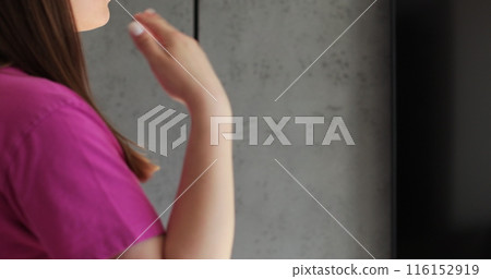 Close up woman waving her hands because of the heat and turned on the air conditioning. Modern technologies. 116152919