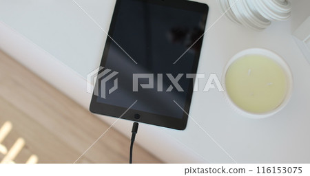 Closeup male hands connecting cable for transfer data. Unrecognizable man plugging cable into Tablet computer. 116153075