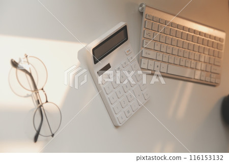 Desk with laptop, eye glasses, earphone, pen and a cup of coffee. Top view with copy space. 116153132