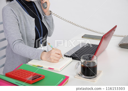 A woman working on a computer A woman working on a computer 116153303