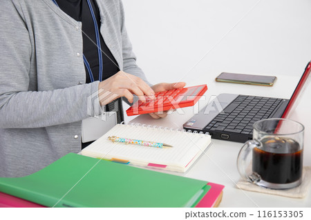 A woman working on a computer A woman working on a computer 116153305
