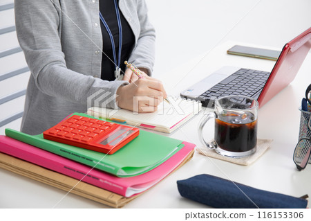 A woman working on a computer A woman working on a computer 116153306