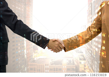 Two business people in suit are shaking hand, symbolizing agreement and partnership, with high rise office building cityscape overlay in the background. Two business people in suit are shaking hand, symbolizing agreement and partnership, with high rise office building cityscape overlay in the background. 116153819