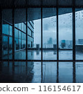 Image of rain falling on large windows of a building 116154617