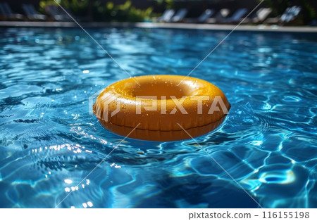 Yellow inflatable ring floating on clear blue pool water under bright sunlight. Summer relaxation Yellow inflatable ring floating on clear blue pool water under bright sunlight. Summer relaxation 116155198