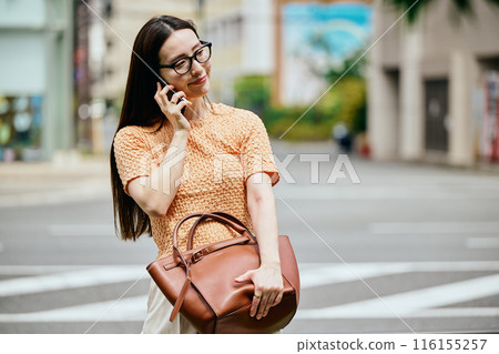 Young woman calling on smartphone Young woman calling on smartphone 116155257