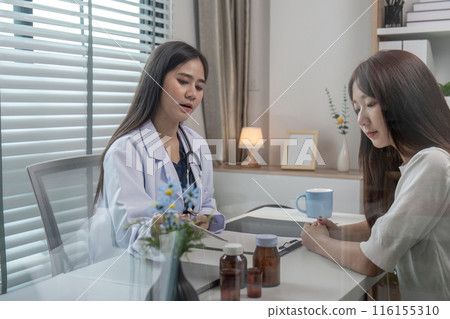 Doctor Consulting Patient in Modern Clinic Office Discussing Symptoms and Medical History for Diagnosis and Treatment 116155310