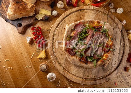 Delicious pizza with prosciutto Delicious pizza with prosciutto 116155963