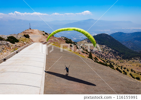 Flying paraglider at Babadag mountain in Turkey Flying paraglider at Babadag mountain in Turkey 116155991