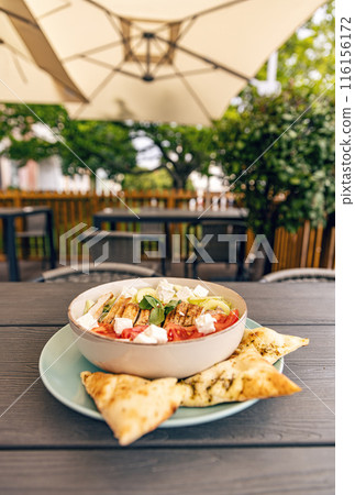 Greek salad with chicken, feta cheese and pita bread Greek salad with chicken, feta cheese and pita bread 116156172