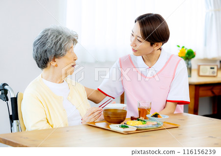 Caregiver and elderly person eating Caregiver and elderly person eating 116156239