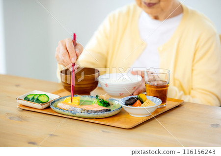 Senior woman eating 116156243