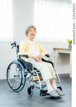 Seniors riding in wheelchairs Seniors riding in wheelchairs 116156252