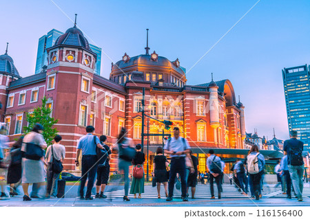 Tokyo cityscape in Japan. Tokyo Station Marunouchi North Exit. People heading to the station after work. Operate their smartphones without worrying about their surroundings. Tokyo cityscape in Japan. Tokyo Station Marunouchi North Exit. People heading to the station after work. Operate their smartphones without worrying about their surroundings. 116156400