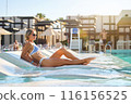 A girl sits near the pool after spa treatments. Turkey, hotel, vacation, travel, girl in a swimsuit 116156525