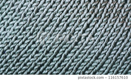 A close up of a knit fabric with a lot of yarn 116157610