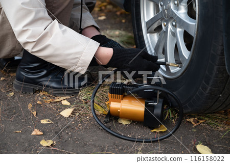 Man car inspection Measure quantity Inflated Rubber tires car.Close up hand holding machine Inflated pressure gauge for car tyre pressure measurement for automotive, automobile image 116158022