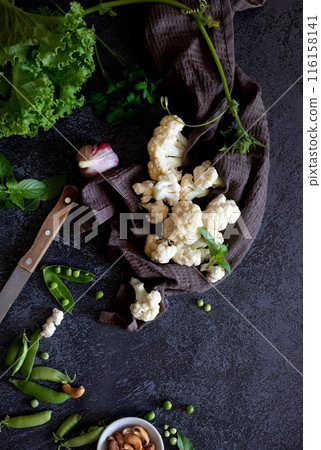 Cauliflower with vegetables and spices on a dark wood background Cauliflower with vegetables and spices on a dark wood background 116158141