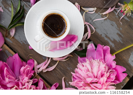 Pink peony flowers and a cup of coffee on a white background. Morninig, spring, fashion composition. Flat lay, top view, copy space. Pink peony flowers and a cup of coffee on a white background. Morninig, spring, fashion composition. Flat lay, top view, copy space. 116158254