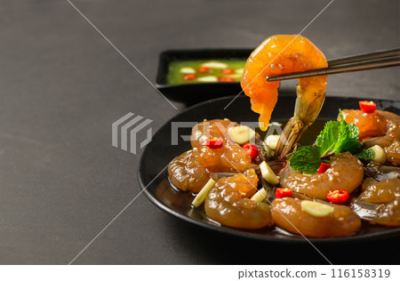 Pickled shrimp with chopstick Soy Sauce, chilli and garlic on stone background, 116158319
