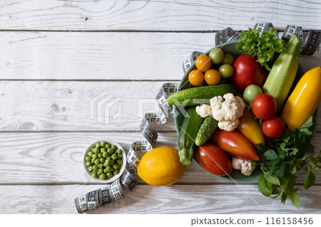 Diet plan, menu or program, roulette, water, dumbbells and diet food from fresh fruits on a white background, the concept of weight loss and detoxification, top view Diet plan, menu or program, roulette, water, dumbbells and diet food from fresh fruits on a white background, the concept of weight loss and detoxification, top view 116158456