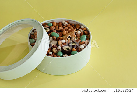 Peanuts in box. Gift to Women's Day (8 March), Women's Day. Mother's Day Valentines day. Festive round box. Peanuts in box. Gift to Women's Day (8 March), Women's Day. Mother's Day Valentines day. Festive round box. 116158524