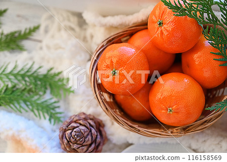 Sweet food top view background for merry christmas or new year holiday decoration - chocolate candies, tangerines, cookies, marshmallow and cocoa latte on white wood 116158569