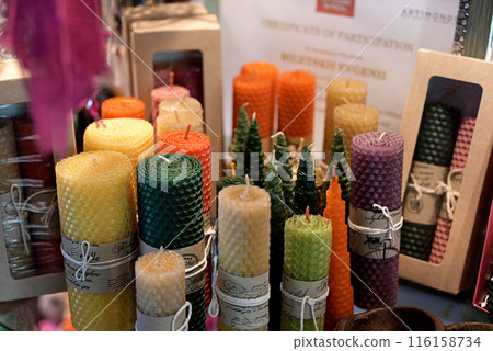 Composition with handmade wax candles, reed diffuser and fruits on color background Composition with handmade wax candles, reed diffuser and fruits on color background 116158734