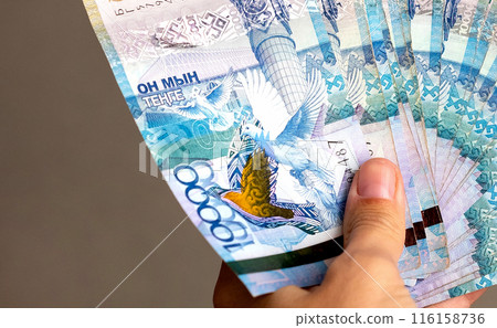 Tenge. Paper Kazakh money and calculator on the table close-up. Tenge. Paper Kazakh money and calculator on the table close-up. 116158736