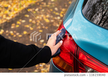 Closeup picture, image young woman, driver, dry wiping her car with microfiber cloth after washing it, cleaning auto, automobile windows. Transportation self service, care concept. Paint protection Closeup picture, image young woman, driver, dry wiping her car with microfiber cloth after washing it, cleaning auto, automobile windows. Transportation self service, care concept. Paint protection 116159040