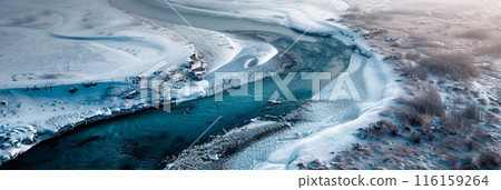 The frozen river's cracked ice patterns are mesmerizing from the air, photography emphasizes the cool blues and whites, presenting a crisp, pristine winter landscape, banner 116159264