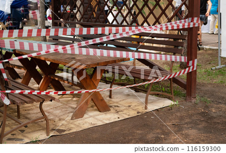 Slide on empty playground in park fenced with red and white attention tape during COVID 19 epidemic Slide on empty playground in park fenced with red and white attention tape during COVID 19 epidemic 116159300