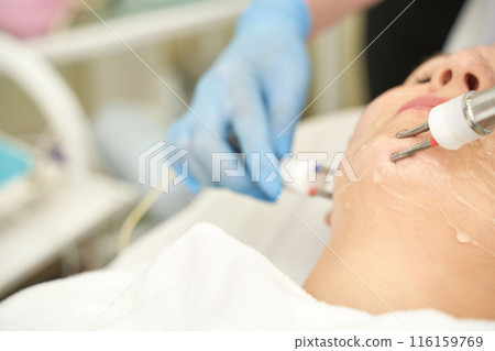 Dermatology anti age treatment. Microcurrent medicine procedure. Woman Dermatology anti age treatment. Microcurrent medicine procedure. Woman 116159769