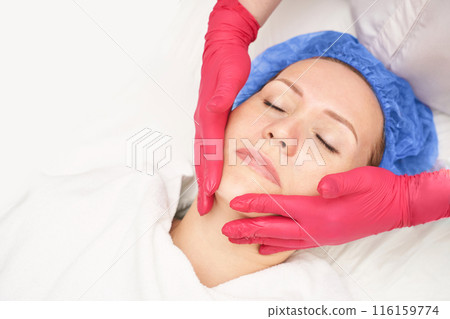 Face massage at luxury spa salon. Doctor hand. Pretty female patient. Beauty Face massage at luxury spa salon. Doctor hand. Pretty female patient. Beauty 116159774