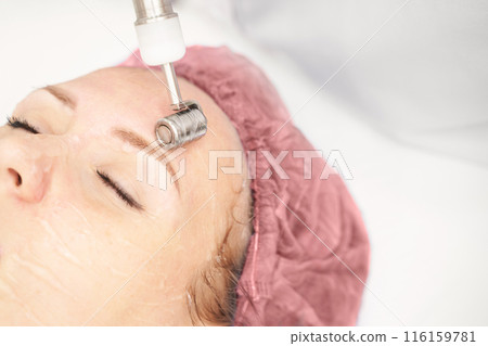 Dermatology anti age treatment. Microcurrent medicine procedure. Woman Dermatology anti age treatment. Microcurrent medicine procedure. Woman 116159781