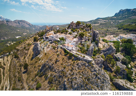 Aerial photography Guadalest hilltop village surrounded mountains. Spain 116159888