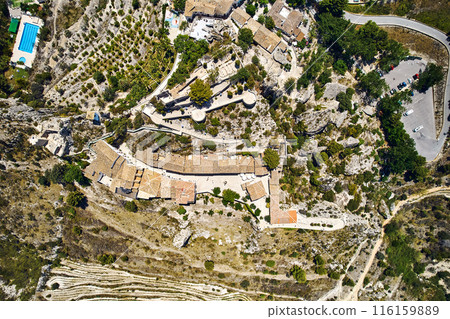 Aerial photography Guadalest hilltop village surrounded mountains. Spain 116159889