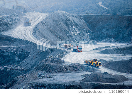 Diabase quarry in Parekklisia, Cyprus with heavy trucks and excavators in operation Diabase quarry in Parekklisia, Cyprus with heavy trucks and excavators in operation 116160044
