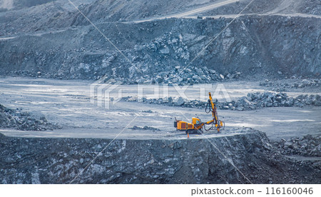 Drilling machine in diabase quarry with rocky terrain. Parekklisia quarry, Cyprus Drilling machine in diabase quarry with rocky terrain. Parekklisia quarry, Cyprus 116160046