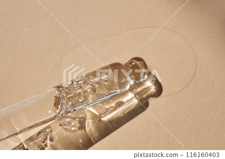 Pipette with serum on a beige background. 116160403