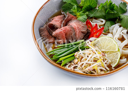 Pho Bo traditional Soup with beef, rice noodles, ginger, lime, chili pepper in bowl. Close up. Vietnamese and Asian cuisine. Pho Bo traditional Soup with beef, rice noodles, ginger, lime, chili pepper in bowl. Close up. Vietnamese and Asian cuisine. 116160781